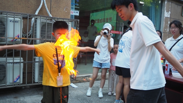 团队成员引导小朋友体验化学实验。beat365中文官方网站供图